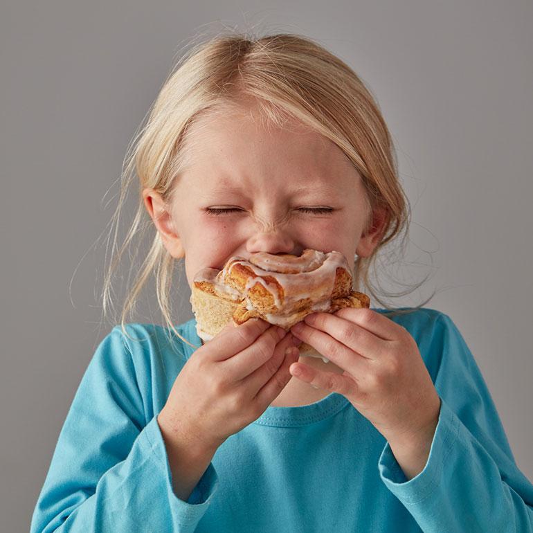 girl eating layered cake